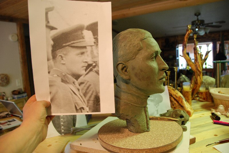 The clay bust in progress and another photograph used to create the clay bust, a commission for the Toronto Airport Authority